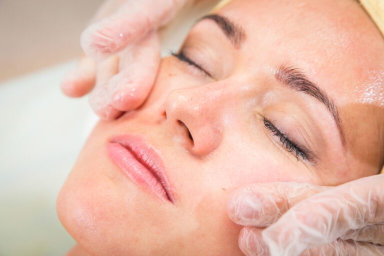 esteticista aplicando limpeza de pele em cliente